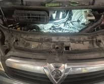 Inside an engine compartment with specialized diagnostic lighting focused on internal components.