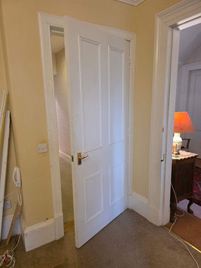 Doorway plastered over to close off a room, marking structural changes and transformation in home remodeling project.