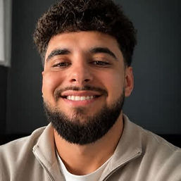 Close up portrait of Adam the founder smiling at the camera