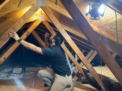 Jorge A. Puentes checking the attic during a home inspection in Orlando, FL