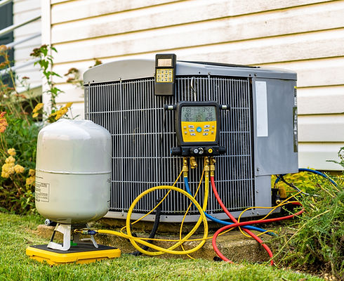 An old air conditioning unit that is being repaired by an HVAC service technician. The tec