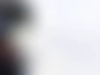 A snowboarder Wearing a snow helmet and goggles