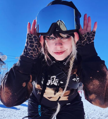 Woman close up photo wearing a black Mad Hatter  snow goggles with mirror lens