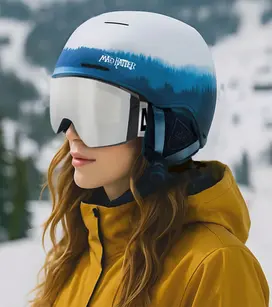 Woman Wearing Cirque snow helmet and goggles with a tan jacket on mountain