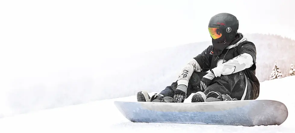 Snowboarder wearing a lightweight snowboarding helmet and reflective snow goggles
