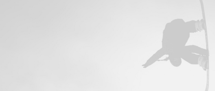 a silouhette of a snowboarder performing a trick