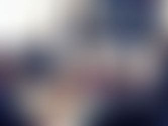 A female executive presenting charts to the team in a boardroom setting.