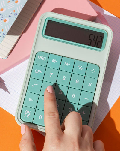 A finger on a calculator.