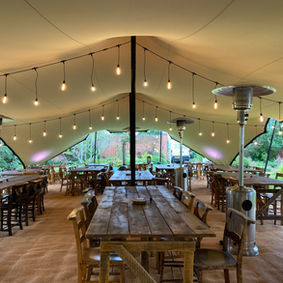 large stretch tent with furniture festoon lighting
