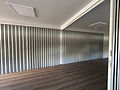Custom central post connecting four commercial folding door sections