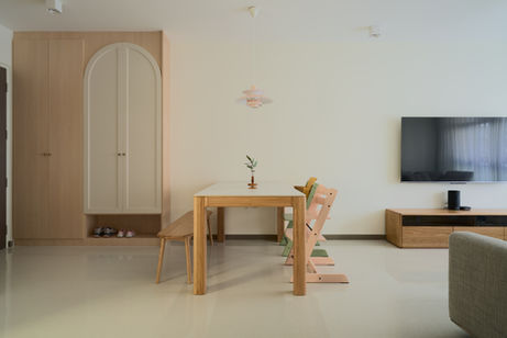 Dining and living space composed with minimal furnishings, allowing flexibility and visual calm.