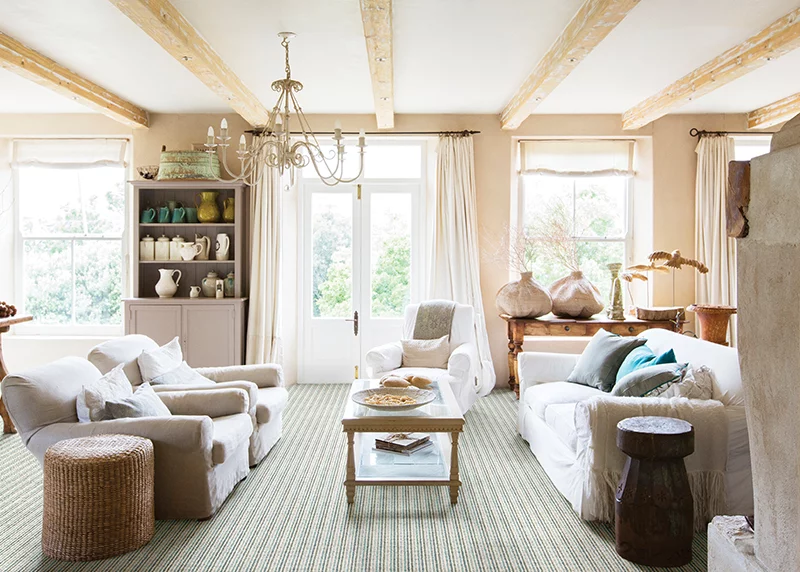 Couristan Burma carpet in Seafoam installed in a coastal style living room with soft blue and neutral decor.
