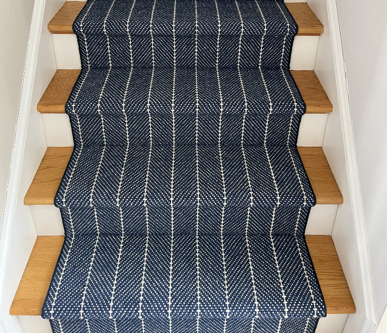 Navy and white herringbone stripe carpet elevates a plain staircase.