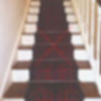 A stair runner carpet that is too narrow for the staircase.
