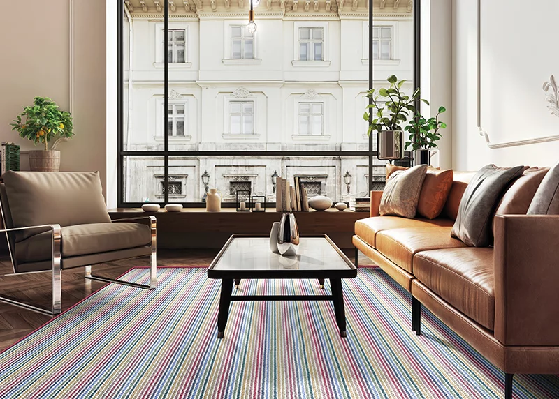 A multi-color wool carpet is a stunning contast to the neutral toned furnishings in a modern living room.