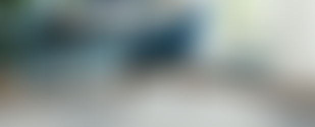 Organic patterned blue and white carpet in room with blue walls and chair.