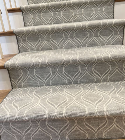 Beautiful abstract wool carpet installed as a runner on stairs.