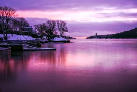 serene purple landscape scene with reflections on lake.