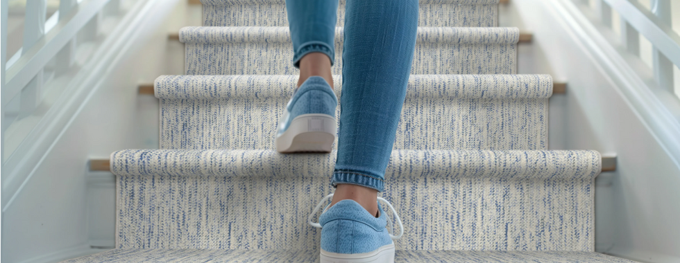 Orgnaic wool carpet with blue flects installed on stairs.