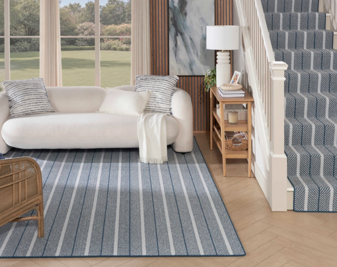 Nourison Westport Stripe carpet in Maritime featured in a coastal hallway and staircase with blue striped carpeting and white trim.