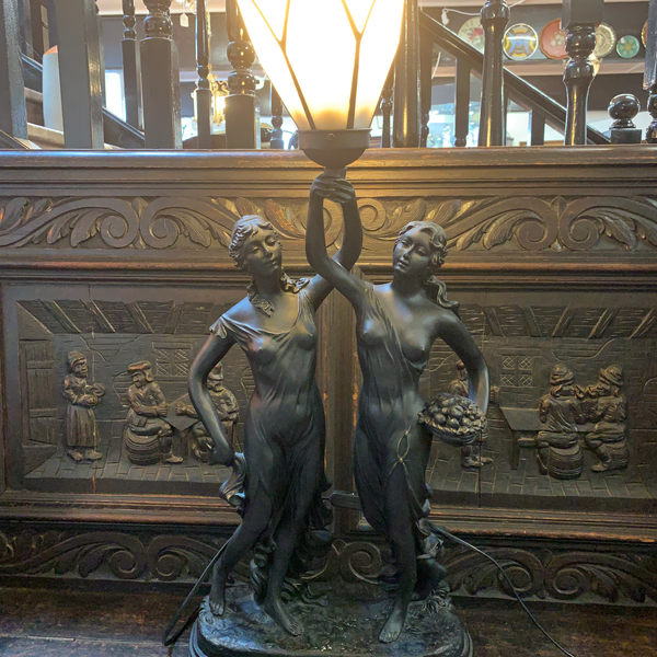 Large Art Nouveau style resin table lamp with stained glass shade supported by t