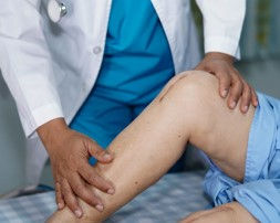 Physical Therapist working with a total knee replacement patient right in their home