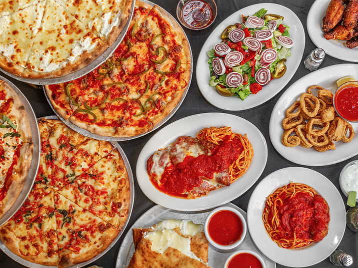 Spread of Italian food: pizzas, spaghetti, calamari, salad