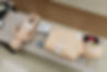CPR training mannequins (infant and adult) with an AED and first aid kit.