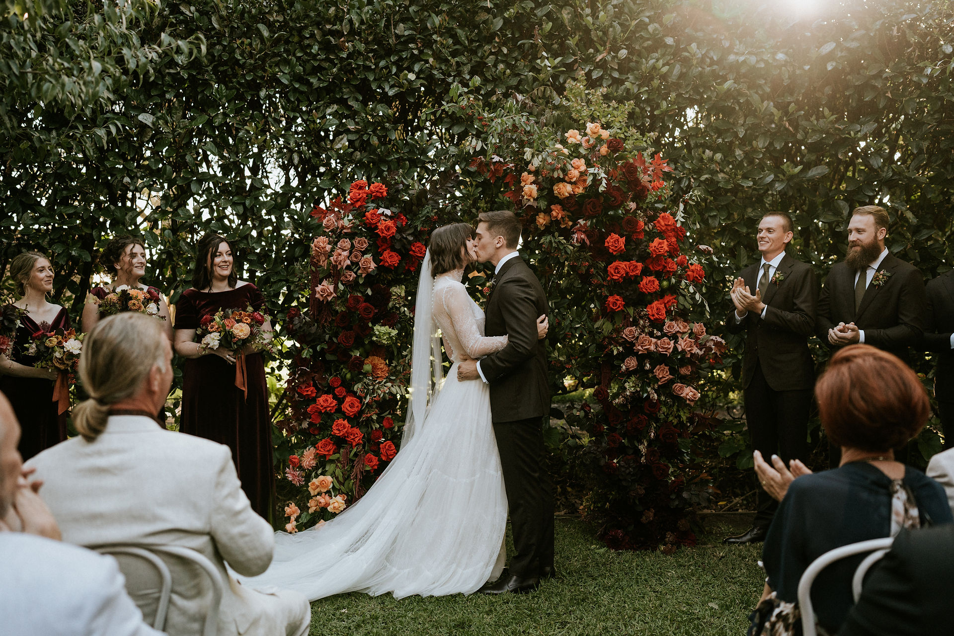 a bride and groom share a first kiss