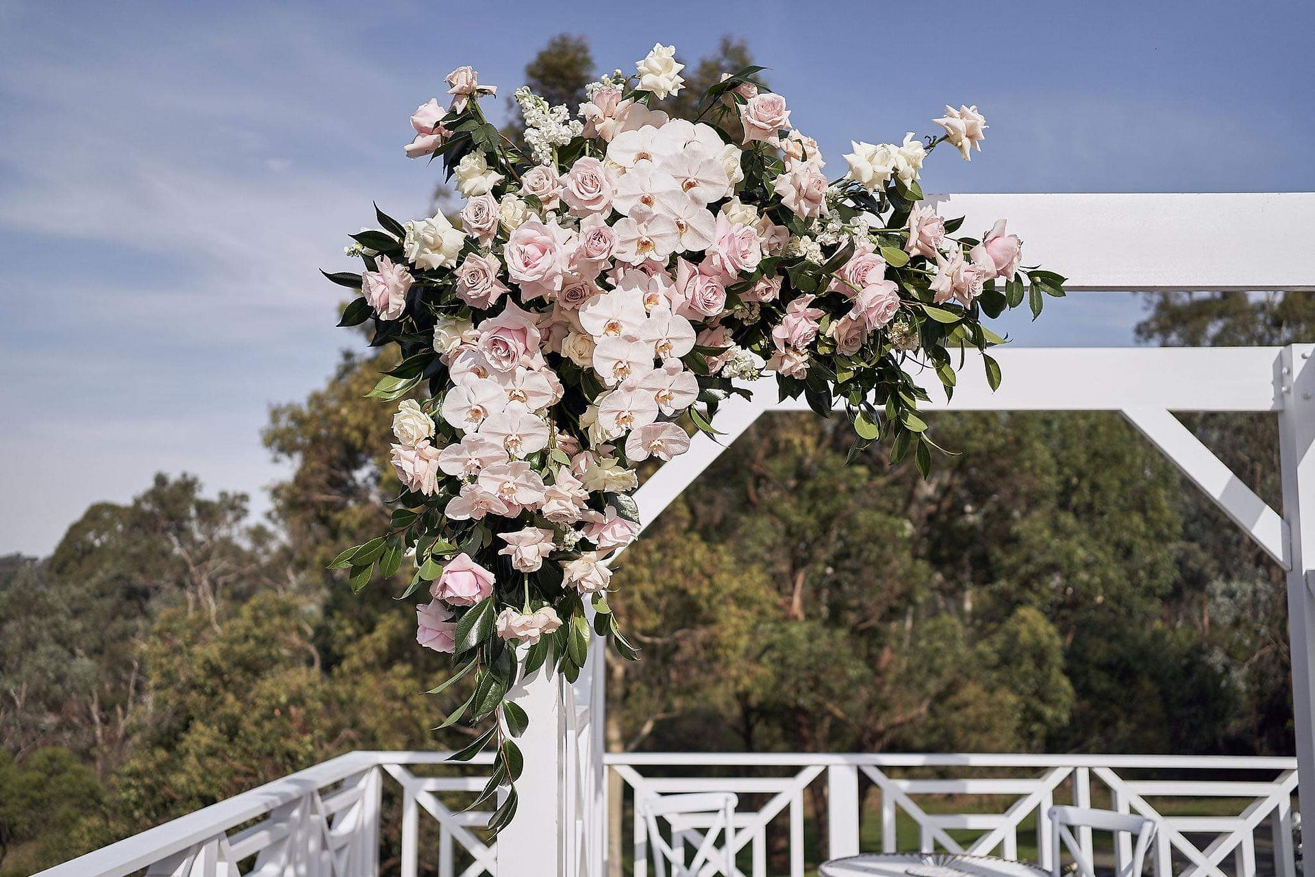 Wedding archway Florals featuring white and pink roses and orchids