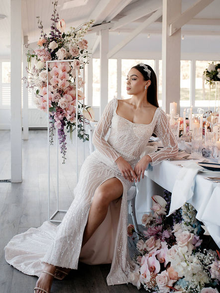 Melbourne Bride sitting at bridal table surrounded by wedding flowers
