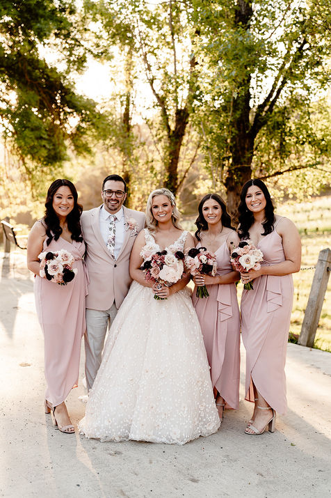 bride and bridesmaids wearing pink holding bouquets