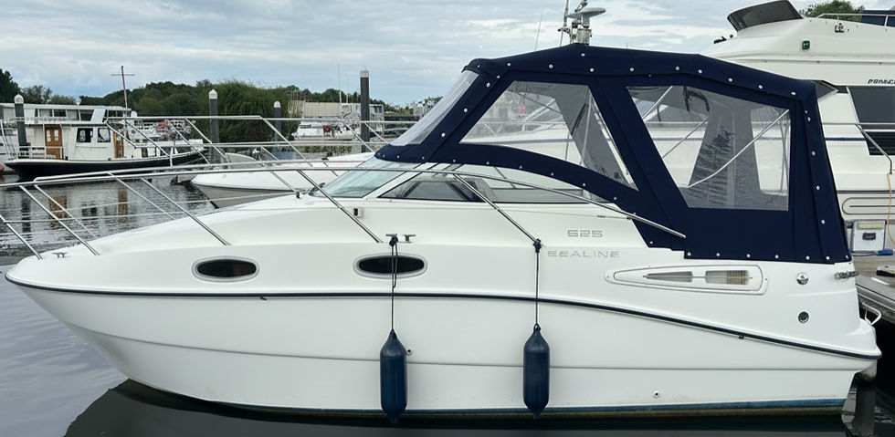 White motorboat with navy blue replacement boat covers.