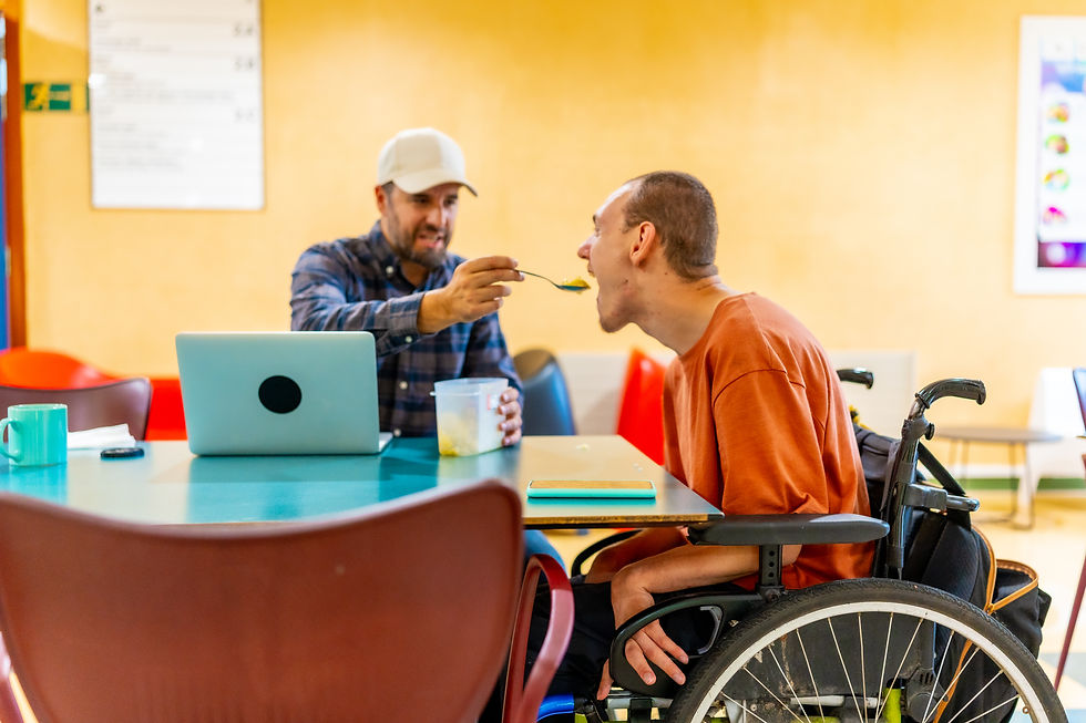 Man wearing cap supports another man to eat