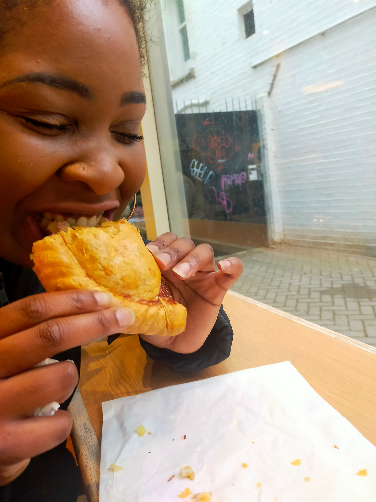 Woman taking a bite out of a traditional Cornish Pasty in Cornwall