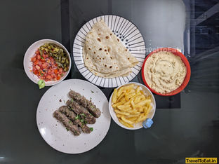 kebab, wraps, french fries, hummus, tomato salad, jalapeno