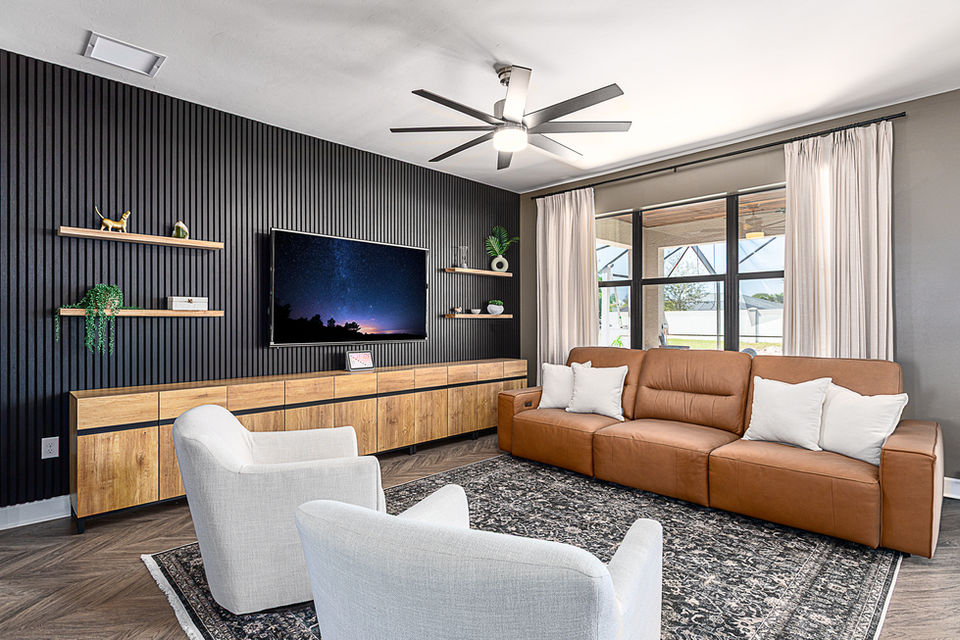Modern living room with wood accents and black feature wall, Fort Myers real estate photography.