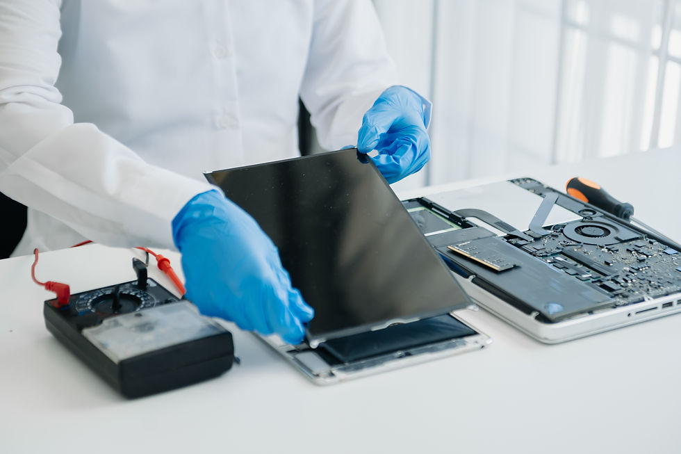 Electronics technician repairing a tablet device in a professional repair shop