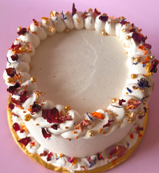 Buttercream cake with swirl pipping, finished with gold pearls, flakes, and dehydrated flowers made to order for local delivery
