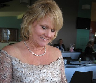 Woman wearing off shoulder dress holding bouquet - Mel Rose Bride