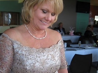 Mel Rose Couture mature bride looking down at bouquet