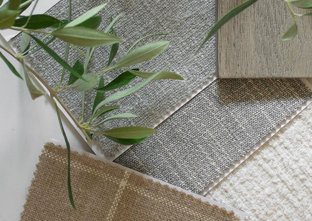 Nursery material board featuring fabric swatches and neutral textures