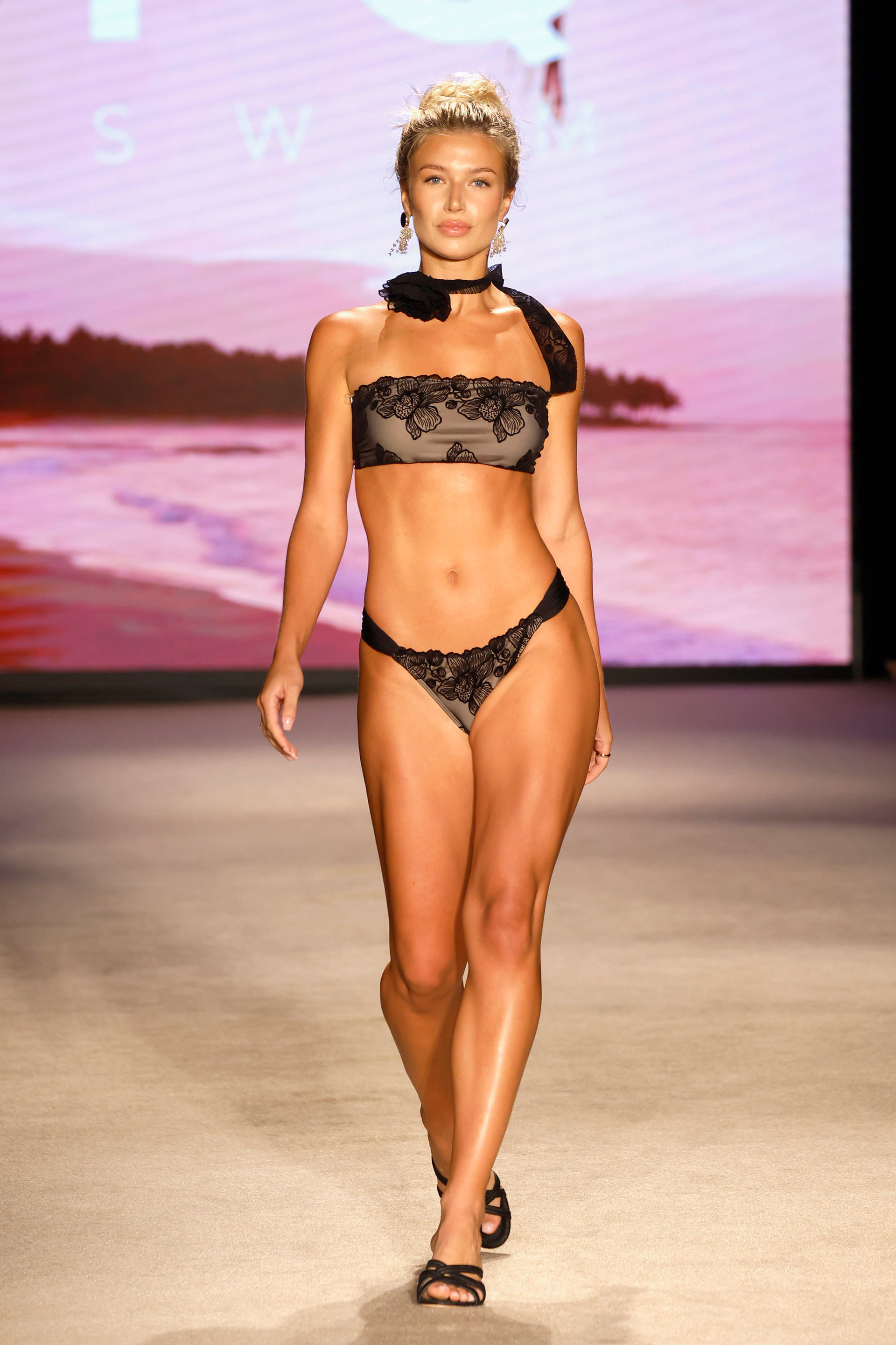 Model walking at PQ Swim's runway show.