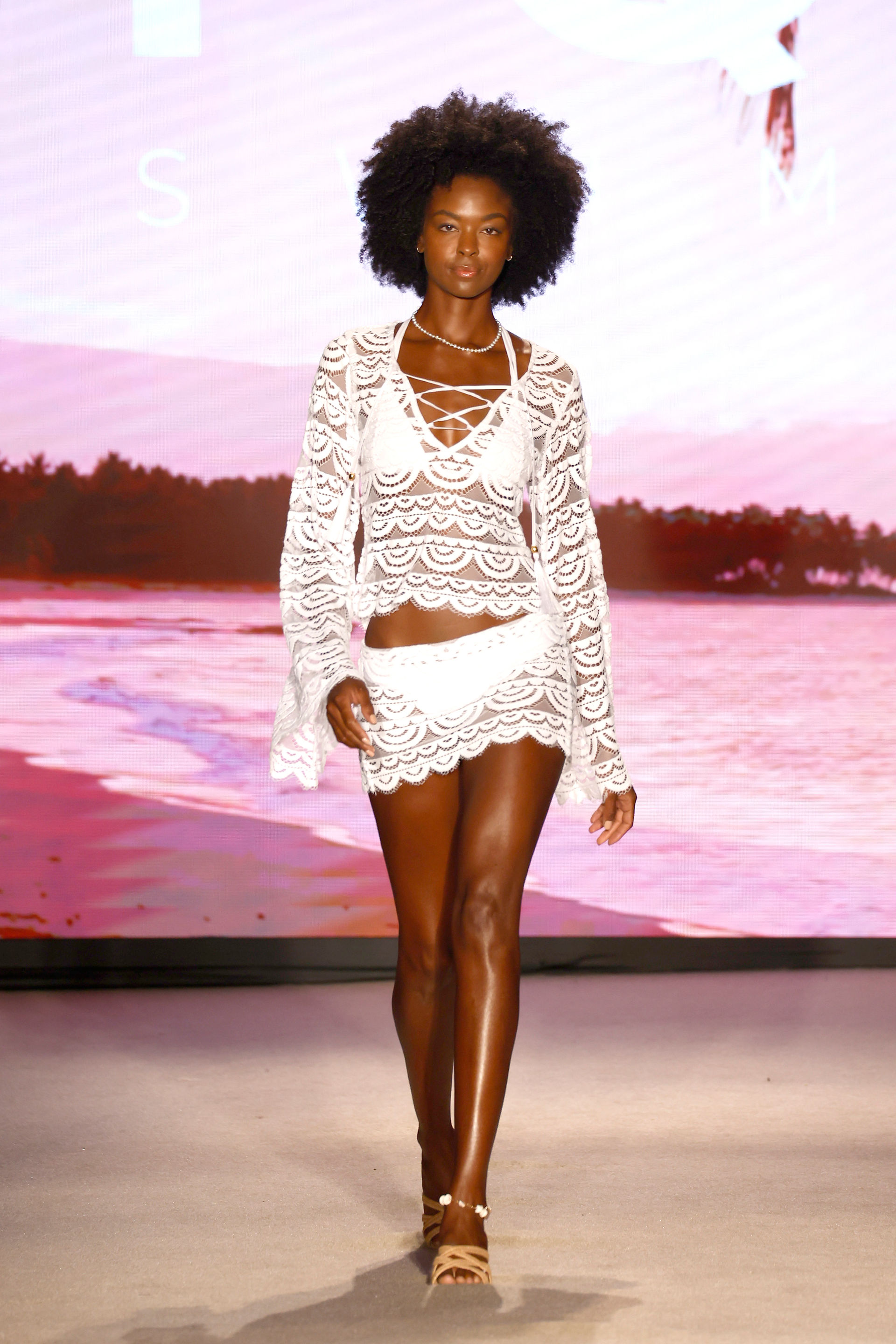 Model walking at PQ Swim's runway show.