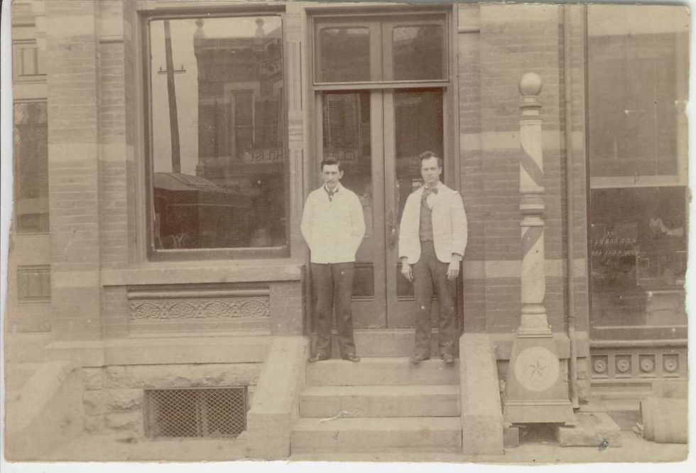 Front entrance of the Hotel Marion barbershop, marked by its striped pole. George Henry Dutton stands at right.