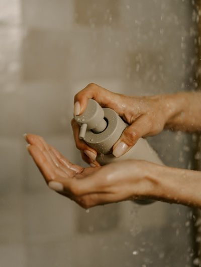 Hands holding a Primally Pure natural deodorant jar, highlighting clean, non-toxic skincare made with simple ingredients.