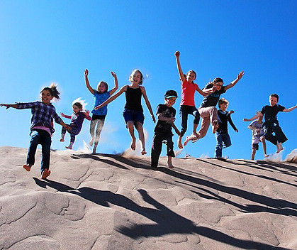 Kids_Jumping_off_Dune_in_Great_Sand_Dunes_National_Park.jpg