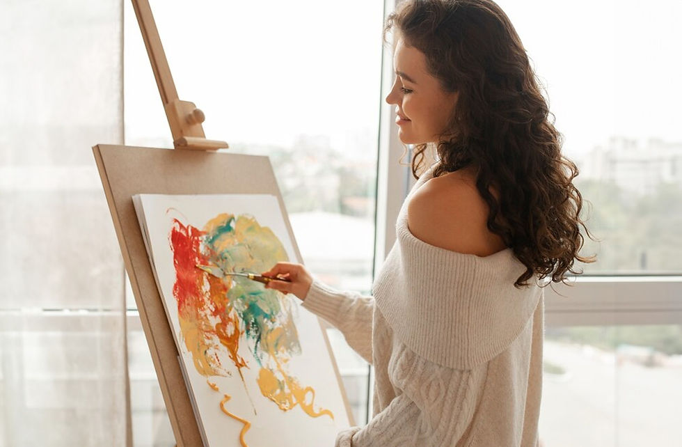 Woman Painting on a canvas in a light airy room
