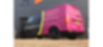 Pink and black van parked outside a gray building, featuring "kitchencreators" logo and contact info. Bright, clear day setting.