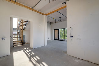 empty-white-room-without-repair-furniture-with-scaffolding-with-wooden-stairs.jpg